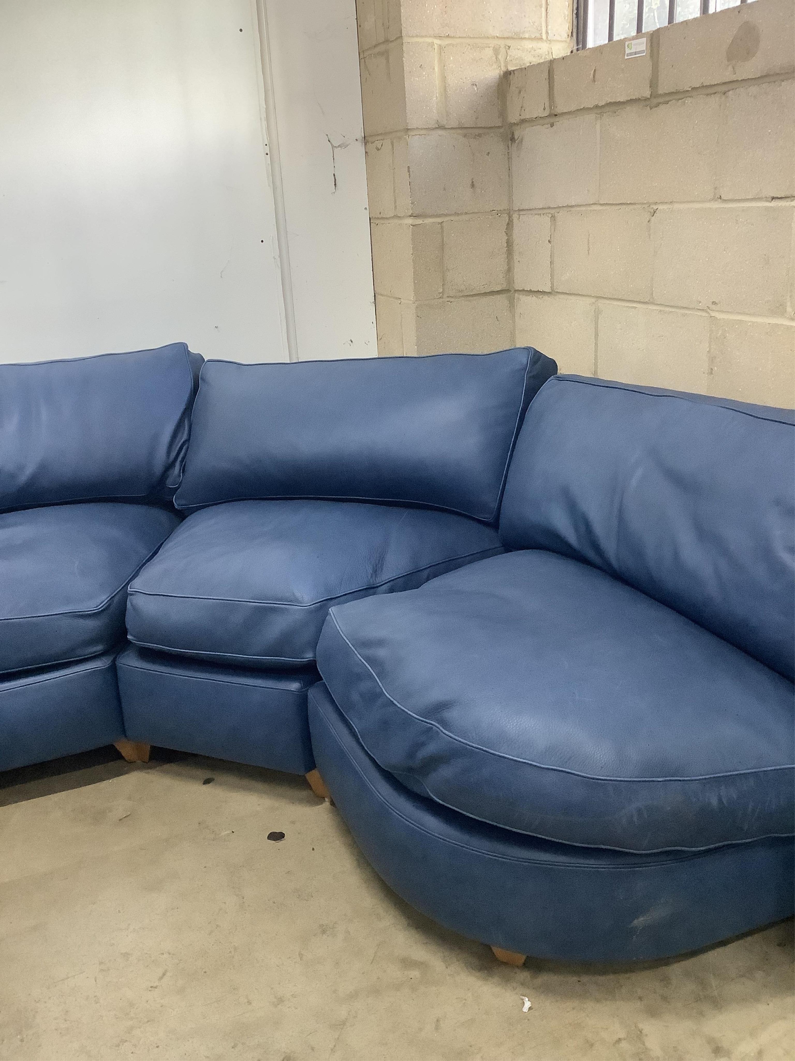 A Contemporary blue leather corner sofa, width 340cm, depth 96cm, height 73cm. Condition - fair